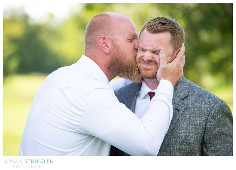groomsman kissing groom